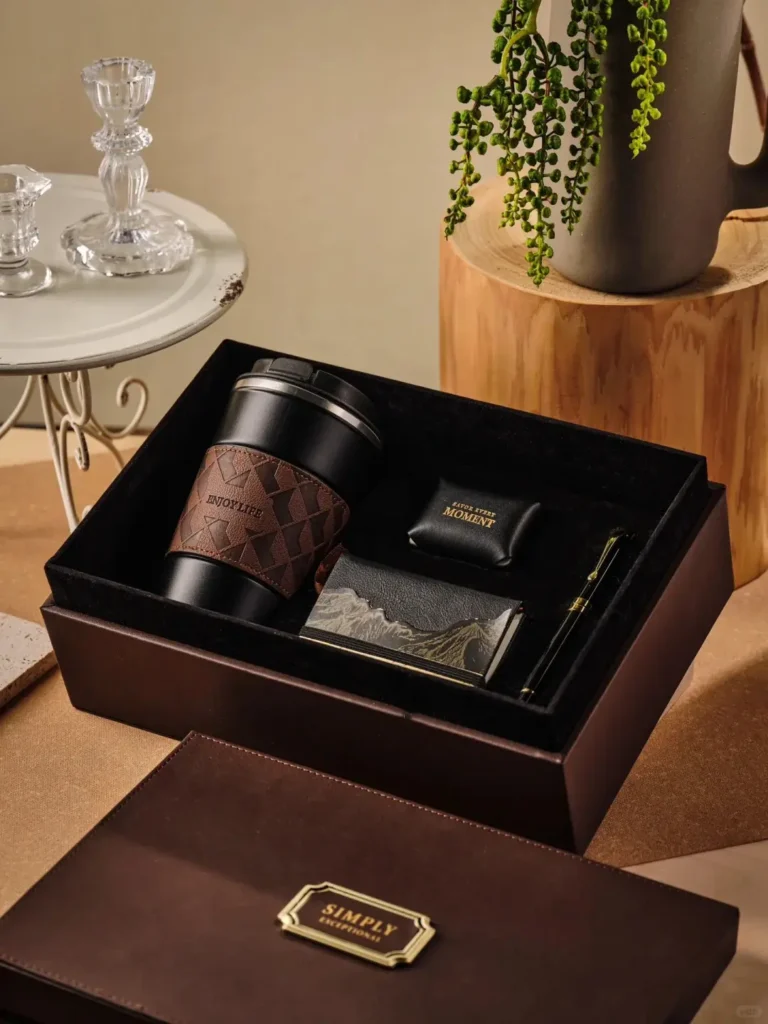 Close-up of leather-inspired gift set showing sleek black-and-gold signature pen and genuine leather notebook