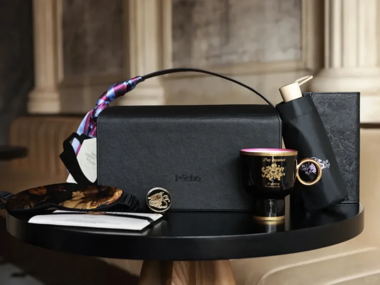 A luxury gift box with a cup of coffee, a stylish umbrella, and a leather wallet, symbolizing thoughtful corporate gifts.