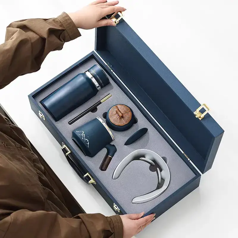 Blue corporate gift box with neck massager, coffee pot, mug, insulated tumbler, and pen – ideal for executive and employee gifts