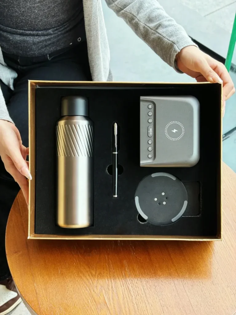 Luxury corporate gift set with tumbler, pen, wireless charging clock, and phone stand for premium corporate gifting.