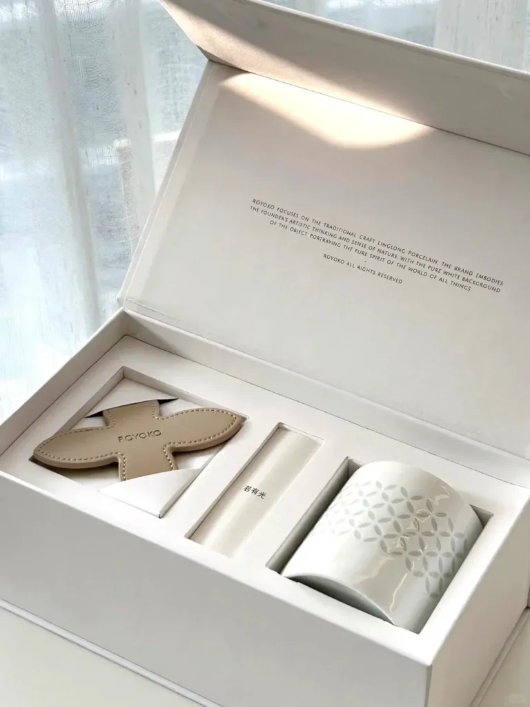 White gift box with Jingdezhen Linglong porcelain cup and leather coaster, featuring traditional Chinese craftsmanship with delicate translucent design.