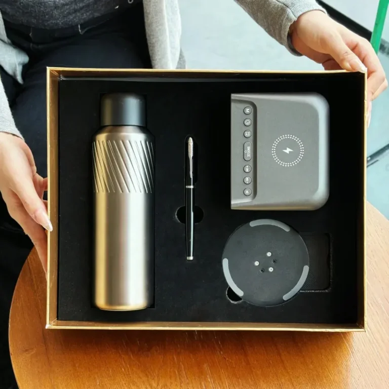 Cover image for "The Ultimate Guide to Corporate Gifting" article, showing a person presenting a customized gift box with a premium thermos, 2-in-1 clock charger, pen, and phone stand