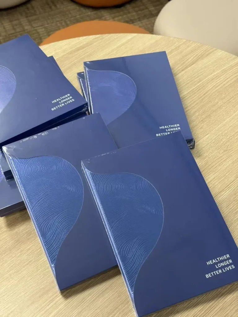 Several branded notebooks, each individually packaged in plastic – promotional gifts and custom promotional items