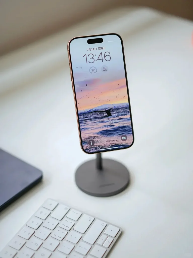 iPhone placed on a branded magnetic phone stand at a trade show