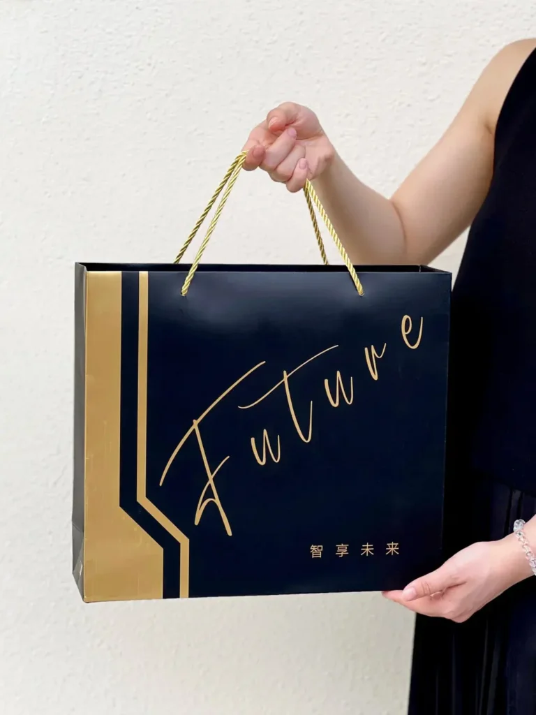 A woman holding a modern employee appreciation tech gift box, presenting it toward the camera — unique employee appreciation gift ideas