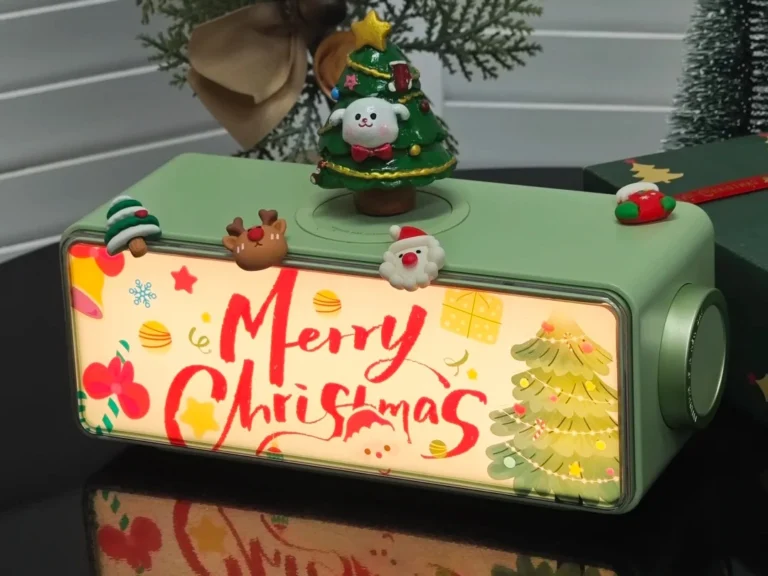 Employee Christmas gift box with Merry Christmas text, featuring multi-function speaker, night light, wireless charger, and festive holiday designs