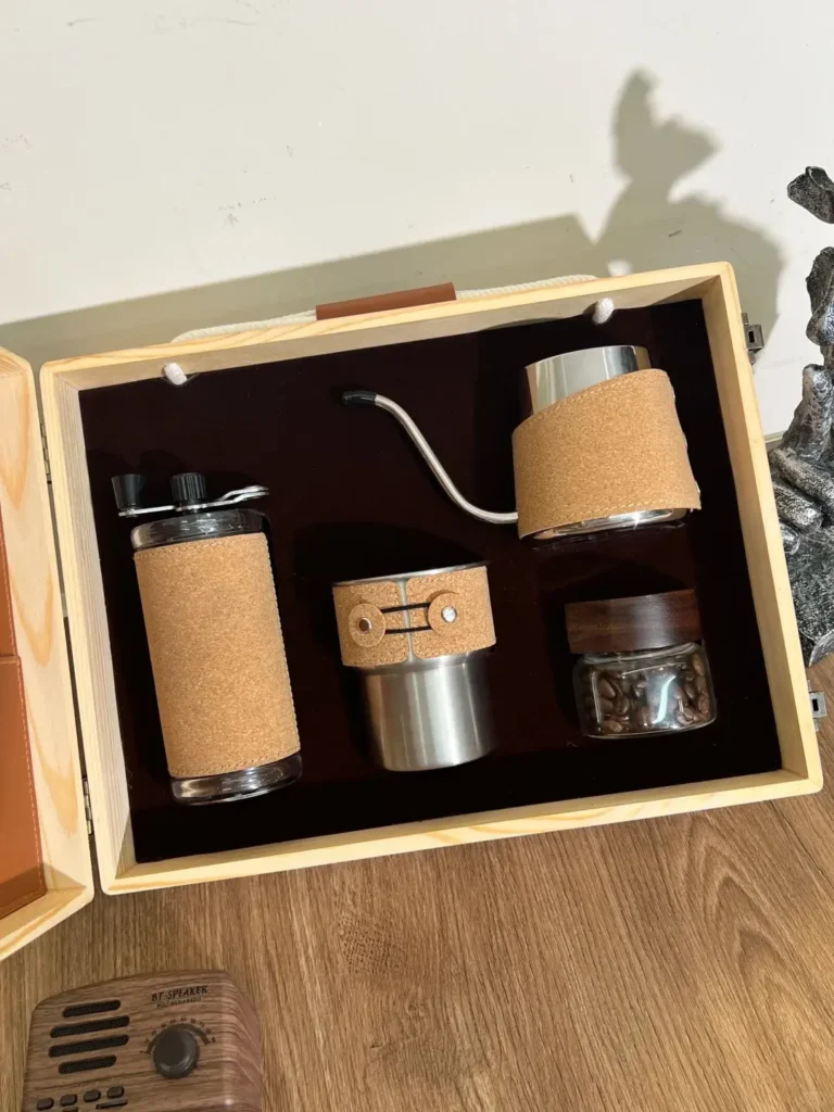 Premium executive coffee gift set featuring a wood-grain and leather box, with coffee cup, manual coffee grinder, pot, and coffee beans — perfect for corporate gifting.