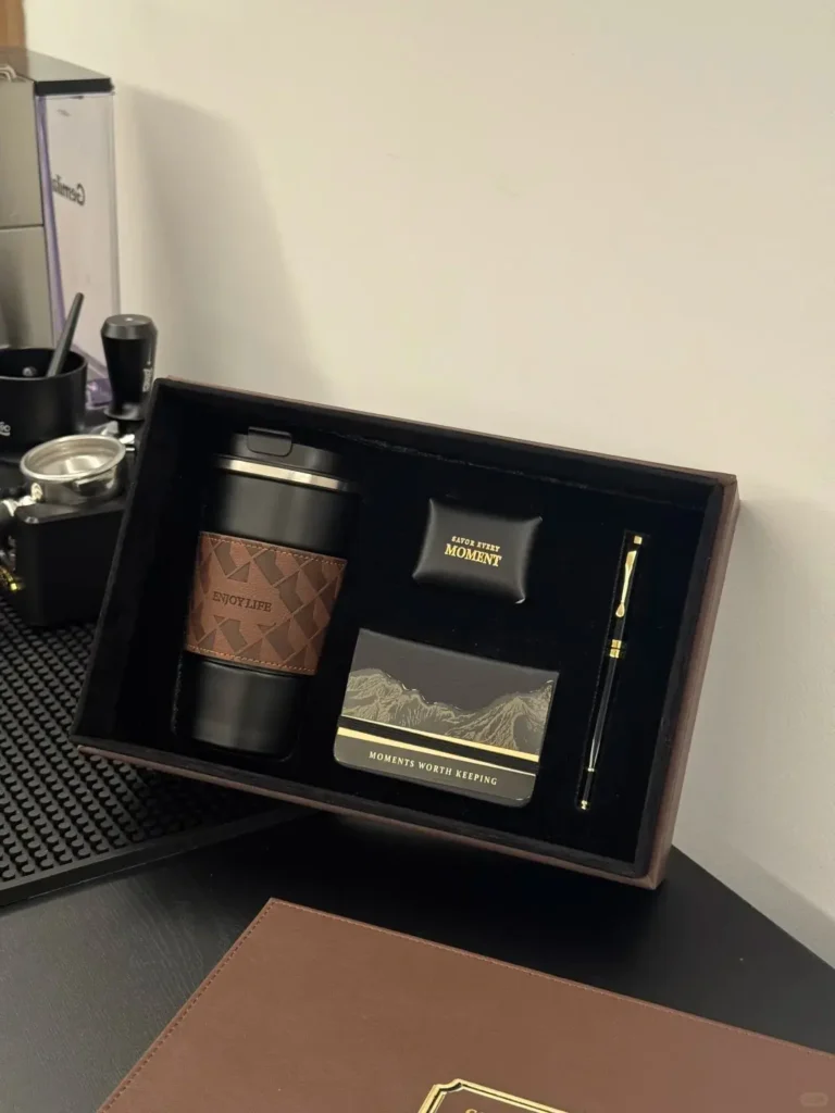 Luxury executive gift set displayed on a desk, featuring a premium leather box, high-end notebook, fountain pen, and insulated tumbler. Perfect for luxury CEO gifts and luxury corporate gifts ideas.