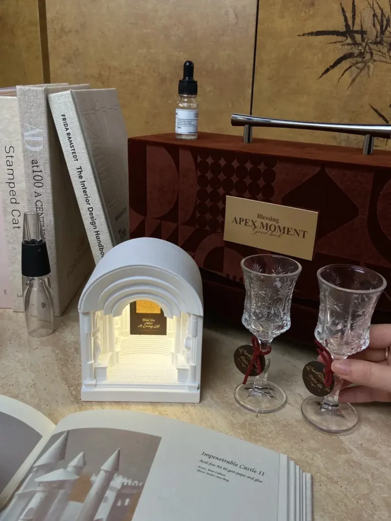 Maillard brown velvet gift set displayed on table with wine glasses, engraved aroma night light, wine stopper, and decanter. A premium option for luxury CEO gifts and luxury corporate gifts ideas.