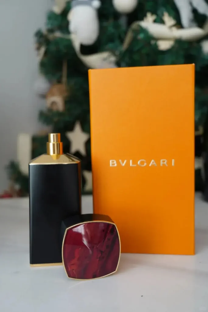 Close-up of an orange scented candle gift box from a corporate Christmas gift set, elegantly displayed on a table for a warm festive touch.