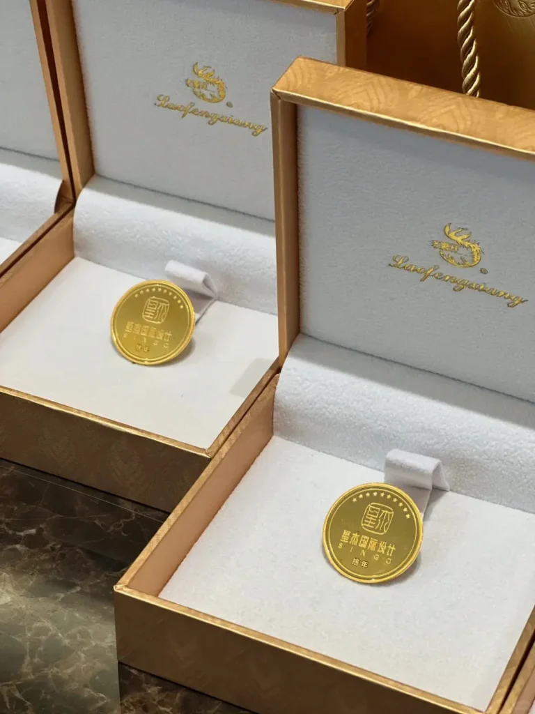 Open view of a company logo gold coin designed as an employee 10 year anniversary gift.