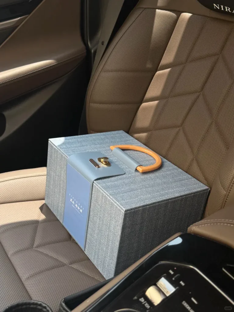 Light blue New Year employee gift box placed on a car seat, styled as a 2026 employee holiday gift with custom on-brand packaging.