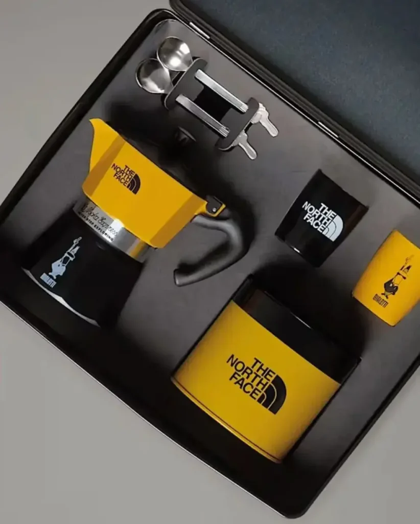 The North Face employee coffee gift box featuring a 3-cup coffee maker, two metallic cups with matching spoons, and a Perfetto Moka Classico coffee blend.