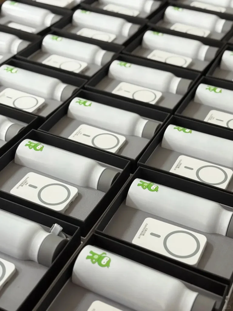 Company logo gifts for employees prepared in bulk, featuring gift boxes with tumblers and wireless charging power banks ready for shipment