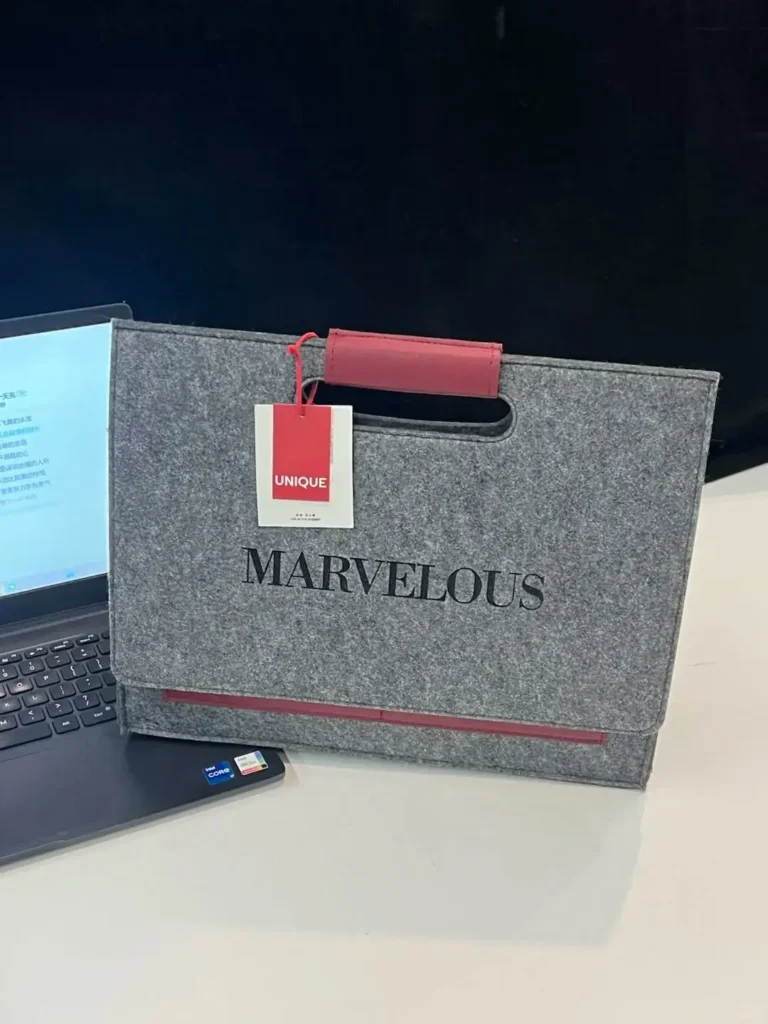 Company swag ideas for employees featuring a branded employee gift bag with company logo